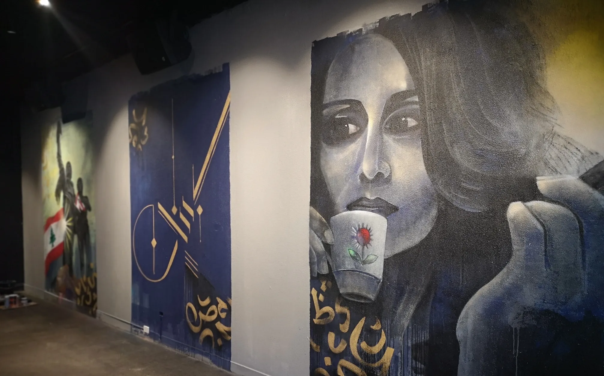 Finished interior mural installation across three wall panels in a venue, including a portrait of a woman drinking tea